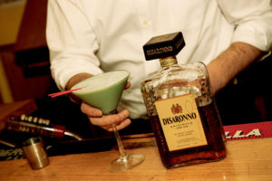 La Mela Bartender with Drink and Disaronno Bottle
